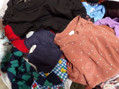 a basket full of clothes that is sitting on the floor