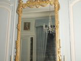 a mirror on the wall above a fireplace in a room