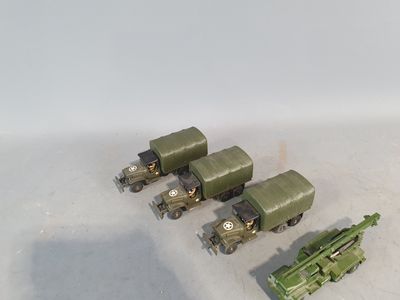four toy army vehicles that are sitting on a table