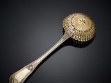 an antique silver spoon with a flower design on the handle