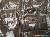 several bags of brown shirts sitting on top of a table