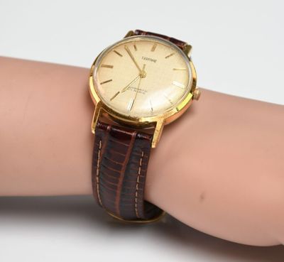 an image of a woman ' s wrist with a watch on it