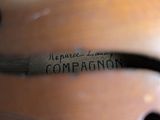 a close up of a violin neck with a label on it