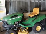 a picture of a lawn mower parked in a garage