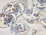 a lot of plates and bowls on the table