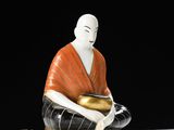 a figurine of a man sitting on a table