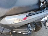 a scooter that is parked on the side of the road