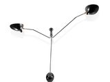 trois lampes noires posées sur une surface blanche, sur fond blanc