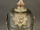 an old helmet with a star on the top of it on a stand
