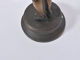 a bronze statue of a man holding a baseball bat