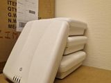 a stack of four white toasters sitting on a counter