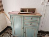 a small cabinet with a sink in the corner of a room