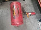 a red fire extinguisor sitting on the floor next to other tools