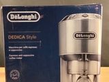 packaging for a delonghi coffee maker on a wooden table