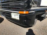 a black truck parked in a parking lot with its hood up
