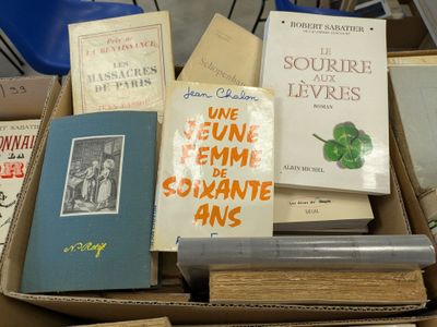 many books in a box on a table