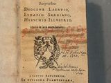 an old book with writing on it sitting on a table