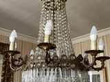 a chandelier hanging from the ceiling in a living room