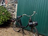 a bike parked in front of a building with a green door