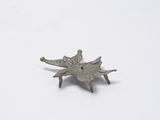 a small metal object that is on a white surface