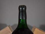 a bottle of wine sitting on top of a wooden box