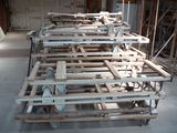 many pieces of wood sitting on top of pallets in a room