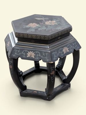 a black and blue table with a flower design on it