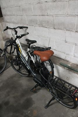 two bikes parked next to each other in a garage
