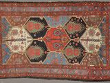 an antique rug with a multicolored design on it