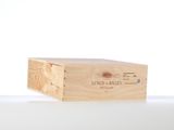 wooden box with a label on it sitting on a white surface