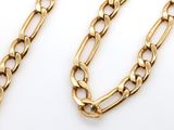 a close up of a gold chain on a white background