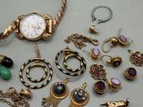 a lot of jewelry that is laying out on the table