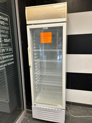 a refrigerator that is sitting outside of a building