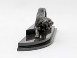 statue of a bull on a black base on a white background