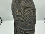 la semelle d'une paire de chaussures noires sur une surface blanche