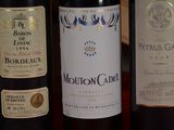 several bottles of wine are lined up on a table