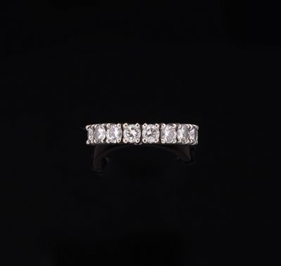 a diamond five stone ring on a black background