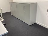 a room with a desk and a phone on the floor