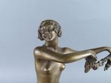 statue of a woman holding a bunch of grapes in her hand
