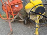 two cement mixers sitting next to each other on the side of the road