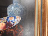 a painting of a bowl of fruit on a table with a vase in the background