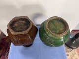 two vases sitting on a blue mat on the floor