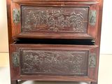two wooden drawers with carvings on them on the floor