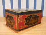 a small box sitting on a table with a striped wall in the background