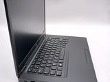 a laptop with a black keyboard sitting on a white surface