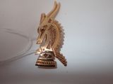 a gold brooch with a dragon head on it
