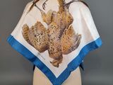 a white and blue scarf with a bird print on it