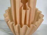 a vase that has a bunch of folded paper in it