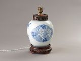 an image of a blue and white vase on a wooden stand