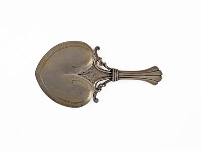 silver plated spoon on a white background with a spoon in the shape of a heart
